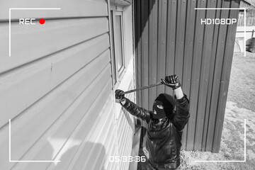 Protection of a private residential building with the help of an external video surveillance system. CCTV view of burglar breaking in to home through window with crowbar. black and white style - obrazy, fototapety, plakaty