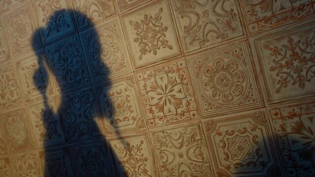 shadows of two lovers on ancient wall, man and woman are caressing, love and passion