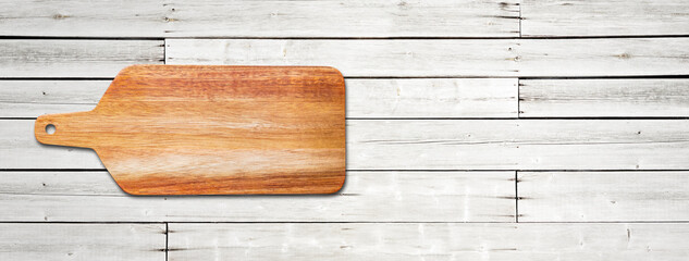 Wooden cutting board isolated on white wood background. Horizontal banner
