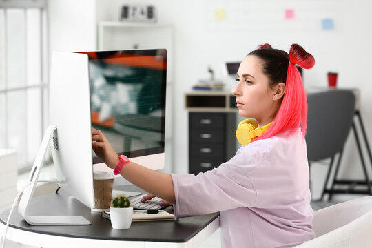 Female programmer working with computer in office