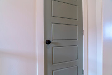 Home interior with close up view of the gray bedroom door with black door knob