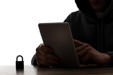 Silhouette of hacker with tablet computer at table on white background