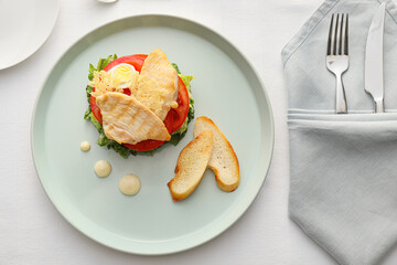 Plate with tasty Caesar salad on light background