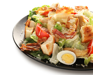 Plate with tasty Caesar salad on white background