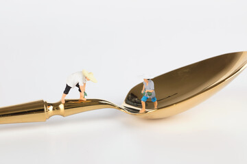 Busy peasant doll model on the golden spoon