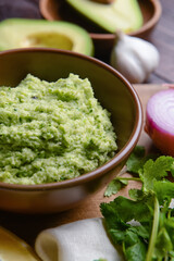 Bowl with tasty guacamole on table, closeup