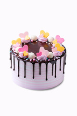 Cake decorated with pink and yellow  colorful hearts chocolate cream  isolated . Copyspace