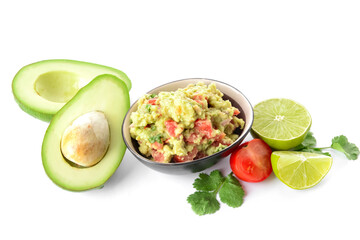 Bowl with tasty guacamole, avocado, lime and tomato on white background
