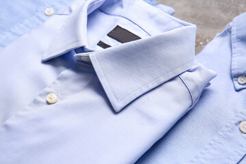 Stylish male shirts on color background, closeup