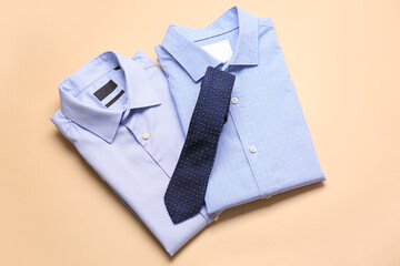 Stylish male shirts with tie on color background