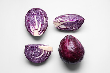 Pieces of fresh purple cabbage on light background