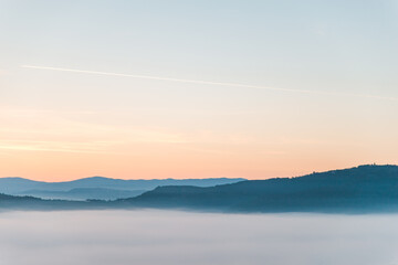 Fototapeta na wymiar view of sunrise above mountains mist in the bottom