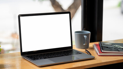 Workspace blank white screen laptop  placed at office desk. Mock up.