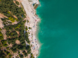 aerial view of people swimming sunbathing resting at sandy beach