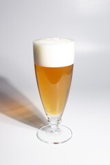 A glass of beer casts a shadow.
