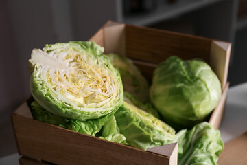 Box with fresh cabbage on kitchen table