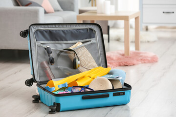 Suitcase with belongings in room