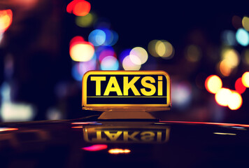 Rooftop sign of Taksi - Turkish Taxi in night street	