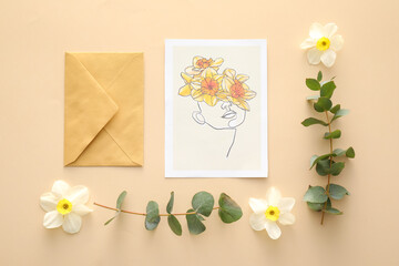 Beautiful greeting card, envelope and narcissus flowers on color background