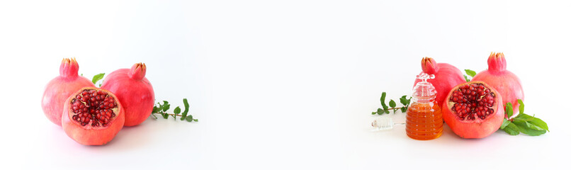 honey and pomegranate isolated on a white. Rosh hashanah (jewish New Year holiday) concept. Traditional symbol