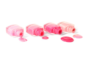 Spilled nail polishes on white background