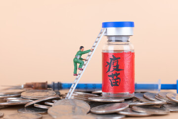 The miniature figure climbs the ladder to a bottle of vaccine medicine