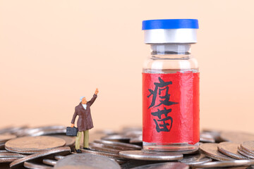 Miniature figures beckoning to the vaccine on the coin