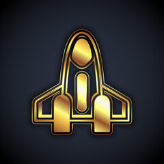 Gold Rocket ship icon isolated on black background. Space travel. Vector
