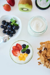 Glass of delicious non-dairy yogurt with fresh berries and muesli, view from above