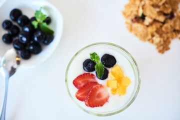 Sweet tasty low calorie dessert with fresh berries on kitchen table, view from above