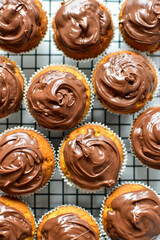 food background of home made banana bread muffins topped with milk chocolate