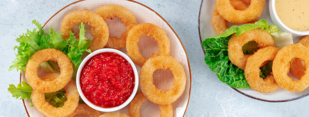 Squid rings panorama. Calamri with salad and marinara sauce, shot from the top. Crispy seafood appetizer