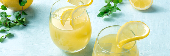 Lemonade panorama. Homemade fresh citrus drink with lemon and mint. Healthy organic detox drink panoramic banner