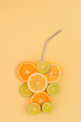 Juicy slices of orange, lemon and lime in the form of a glass, on an orange background. Citrus juice concept.