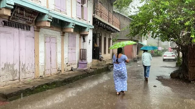 Local Woman On Rainy Street At Temple Town Of Trimbakeshwar City In Trimbak, Maharashtra, India. - Slow Motion