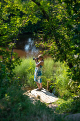 Woman taking photos on rever in summer