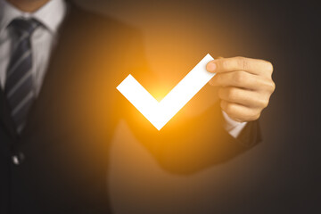 Businessman hand holding virtual approved check mark and Checklist concept