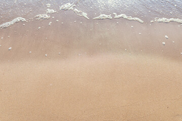 Soft wave of the sea on the sandy beach.Soft focus,blurred image.