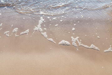 Soft wave of the sea on the sandy beach.Soft focus,blurred image.