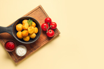 Composition with fried potato balls on color background