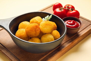 Composition with fried potato balls on color background