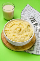 Composition with tasty mashed potatoes on color background