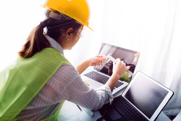 engineer working at a drawings of house in office for discussing. Engineering tools and...
