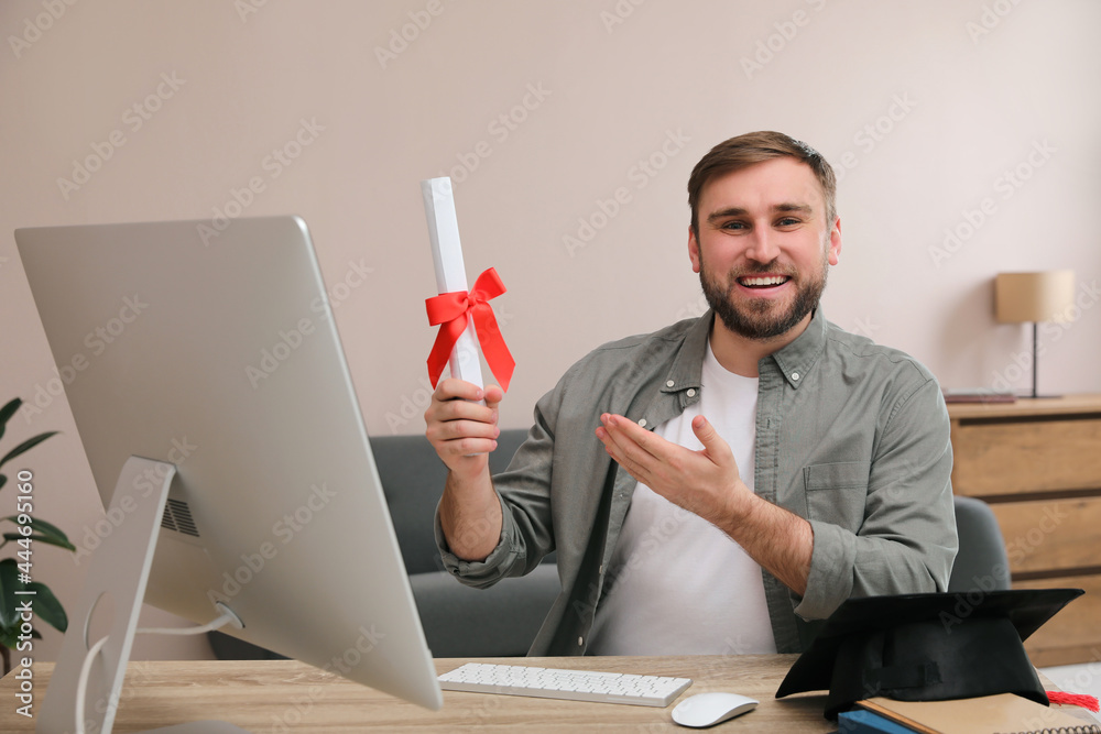 Poster Happy student with graduation hat and diploma at workplace in office