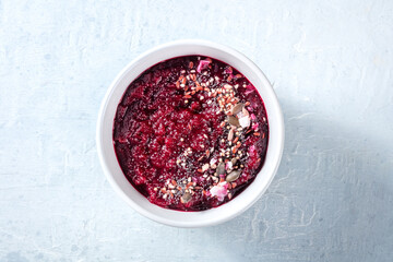 Cold beetroot soup, healthy vegan detox dinner. Beet cream with seeds, summer food, shot from above