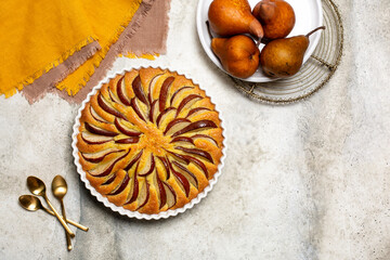 Homemade pie with brown pears.  Autumn colors. Light background, copy space.