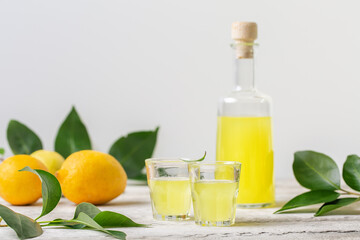 Limoncello - italian lemon liqueur. Light background, copy space.