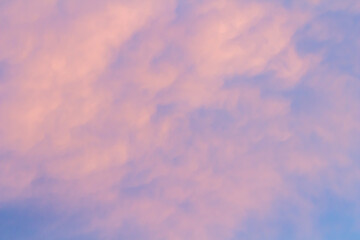 Sunset sky background with pink, purple and blue dramatic colorful clouds, vast sunset sky landscape