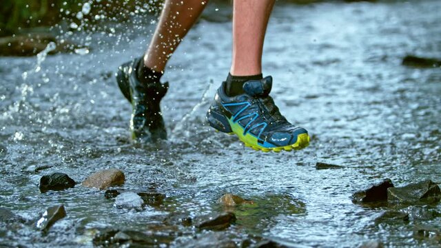 Super Slow Motion Detail Shot of Man Running Across The River at 1000 fps.