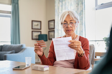 Senior woman checking medicine leaflet